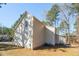 Rear exterior view of home featuring siding, trees, and backyard at 138 Sherwood Ln, Sanford, NC 27332