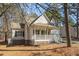 View of the home's front exterior featuring a cozy front porch, and a brick foundation at 138 Sherwood Ln, Sanford, NC 27332
