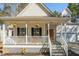 Charming front porch with hanging flower baskets, rocking chairs, and a welcoming front door at 138 Sherwood Ln, Sanford, NC 27332
