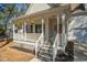 Cozy front porch with rocking chairs, hanging plants, and a welcoming front entrance with sidelights at 138 Sherwood Ln, Sanford, NC 27332