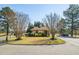 A charming guard house nestled in a manicured green space serves as a welcoming entry point to the community at 138 Sherwood Ln, Sanford, NC 27332