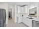 Bright kitchen featuring white cabinets, marble countertops, and stainless steel appliances at 138 Sherwood Ln, Sanford, NC 27332