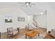 Bright living room featuring vaulted ceilings, a ceiling fan, stairs, and sleek wood floors at 138 Sherwood Ln, Sanford, NC 27332