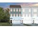 Stylish townhome featuring a gray and white facade, attached garage, and well-manicured lawn at 1413 Chrysalis Pl, Apex, NC 27502