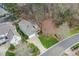 Aerial view of a well-maintained property, featuring a spacious lot, mature trees, and a neatly landscaped yard at 1428 Heritage Links Dr, Wake Forest, NC 27587