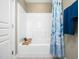 Well-maintained bathroom featuring a shower and a blue and white shower curtain at 1428 Heritage Links Dr, Wake Forest, NC 27587