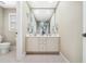 Clean bathroom with a double vanity, large mirror, and neutral color scheme at 1428 Heritage Links Dr, Wake Forest, NC 27587