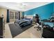 Bright bedroom with blue accent wall, large window, and ceiling fan at 1428 Heritage Links Dr, Wake Forest, NC 27587