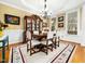 Elegant dining room with hardwood floors, classic decor, a decorative area rug, and ample natural light at 1428 Heritage Links Dr, Wake Forest, NC 27587