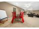 Finished basement game room with modern red chairs surrounding a glass table and additional seating area at 1428 Heritage Links Dr, Wake Forest, NC 27587