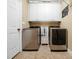 Functional laundry room equipped with modern washer and dryer units and storage cabinets at 1428 Heritage Links Dr, Wake Forest, NC 27587