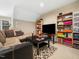 Cozy living room featuring a comfortable sofa, TV, and built-in shelving for storage and display at 1428 Heritage Links Dr, Wake Forest, NC 27587