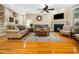 Bright living room features a fireplace, hardwood floors, and comfortable seating on decorative area rug at 1428 Heritage Links Dr, Wake Forest, NC 27587