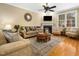 Inviting living room with a cozy fireplace, plush seating, and stylish decor on hardwood flooring at 1428 Heritage Links Dr, Wake Forest, NC 27587
