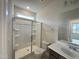 Modern bathroom with a glass shower enclosure and white countertop at 145 Bering Cir, Angier, NC 27501