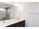 Modern bathroom with double sinks, white countertops, dark cabinets, and a walk-in shower at 145 Bering Cir, Angier, NC 27501