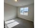 Cozy carpeted bedroom with a window providing plenty of natural light at 145 Bering Cir, Angier, NC 27501