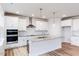 Modern kitchen features white cabinets, granite countertops, an island, and stainless steel appliances at 145 Bering Cir, Angier, NC 27501