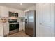 Well-equipped kitchen with stainless appliances, white cabinets and solid surface counters at 146 Holton St, Smithfield, NC 27577