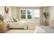 Bright main bedroom with a large window, cozy seating, and a relaxing atmosphere at 1524 Goldfinch Perch Ln, Knightdale, NC 27545