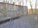 Wood deck with diagonal railing design and wooden bench in backyard at 1703 St. Mary'S St, Raleigh, NC 27608