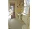 Bathroom with white pedestal sink, blue and white tile floor and a window at 1703 St. Mary'S St, Raleigh, NC 27608