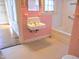 Bathroom sink and tiled tub/shower with pink and white walls and view of the window at 1703 St. Mary'S St, Raleigh, NC 27608