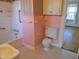Bathroom with tiled shower, toilet, and flooring with pink and white walls at 1703 St. Mary'S St, Raleigh, NC 27608