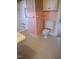 Bathroom with tiled shower, toilet, and flooring with pink and white walls and white cabinets at 1703 St. Mary'S St, Raleigh, NC 27608