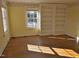 Bedroom with hardwood floors, two windows and built in shelving at 1703 St. Mary'S St, Raleigh, NC 27608