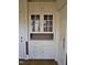 Built in hutch featuring glass front cabinets, drawers and a countertop at 1703 St. Mary'S St, Raleigh, NC 27608