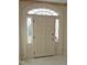 A decorative arched door with sidelights makes an inviting home entrance at 1703 St. Mary'S St, Raleigh, NC 27608