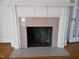 A fireplace with a decorative mantel and pink marble surround gives a classic architectural touch at 1703 St. Mary'S St, Raleigh, NC 27608