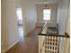 Upstairs hallway with hardwood floors, white and dark stained banister, and wallpaper at 1703 St. Mary'S St, Raleigh, NC 27608