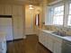 Traditional kitchen with white cabinets, countertops, and hardwood flooring at 1703 St. Mary'S St, Raleigh, NC 27608