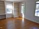 Bright room with hardwood floors, built-in shelves and three windows offering an abundance of natural light at 1703 St. Mary'S St, Raleigh, NC 27608