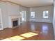 Sunlit living room featuring hardwood floors, a fireplace, and French doors leading to another room at 1703 St. Mary'S St, Raleigh, NC 27608