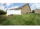 Grassy backyard with a privacy fence and brick exterior, providing a tranquil outdoor space at 1914 Tweed Ln, Burlington, NC 27215