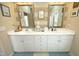 Bathroom featuring double sinks, ample counter space, and elegant lighting fixtures at 1914 Tweed Ln, Burlington, NC 27215