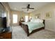 Comfortable bedroom with ceiling fan, neutral decor, and well-lit ambiance at 1914 Tweed Ln, Burlington, NC 27215