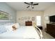 Bright bedroom with a ceiling fan and natural light features a comfortable bed and charming decor at 1914 Tweed Ln, Burlington, NC 27215