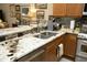 A modern kitchen with granite countertops, stainless steel appliances, and stylish mosaic tile backsplash at 1914 Tweed Ln, Burlington, NC 27215