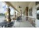 Covered patio with stone columns, ceiling fans, and comfortable seating area, perfect for outdoor relaxation at 1914 Tweed Ln, Burlington, NC 27215