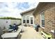 Back patio featuring outdoor seating, a small table, and a well-kept brick exterior at 1914 Tweed Ln, Burlington, NC 27215