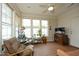 Inviting sunroom with ceiling fan, tile flooring, and large windows overlooking the scenic outdoors at 1914 Tweed Ln, Burlington, NC 27215