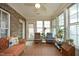 Bright sunroom with brick accent wall, comfortable seating, and abundant natural light at 1914 Tweed Ln, Burlington, NC 27215
