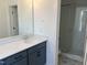 Bathroom showcasing sleek vanity with quartz counters and tiled walk-in shower at 1919 Plott Balsam Dr, Wendell, NC 27591