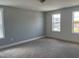Bedroom with carpet, neutral walls, and two windows providing ample natural light at 1919 Plott Balsam Dr, Wendell, NC 27591