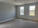 Bright, airy bedroom features two windows for natural light and neutral decor at 1919 Plott Balsam Dr, Wendell, NC 27591