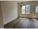 Bright dining area with wood-look floors, a modern light fixture, and natural light at 1919 Plott Balsam Dr, Wendell, NC 27591